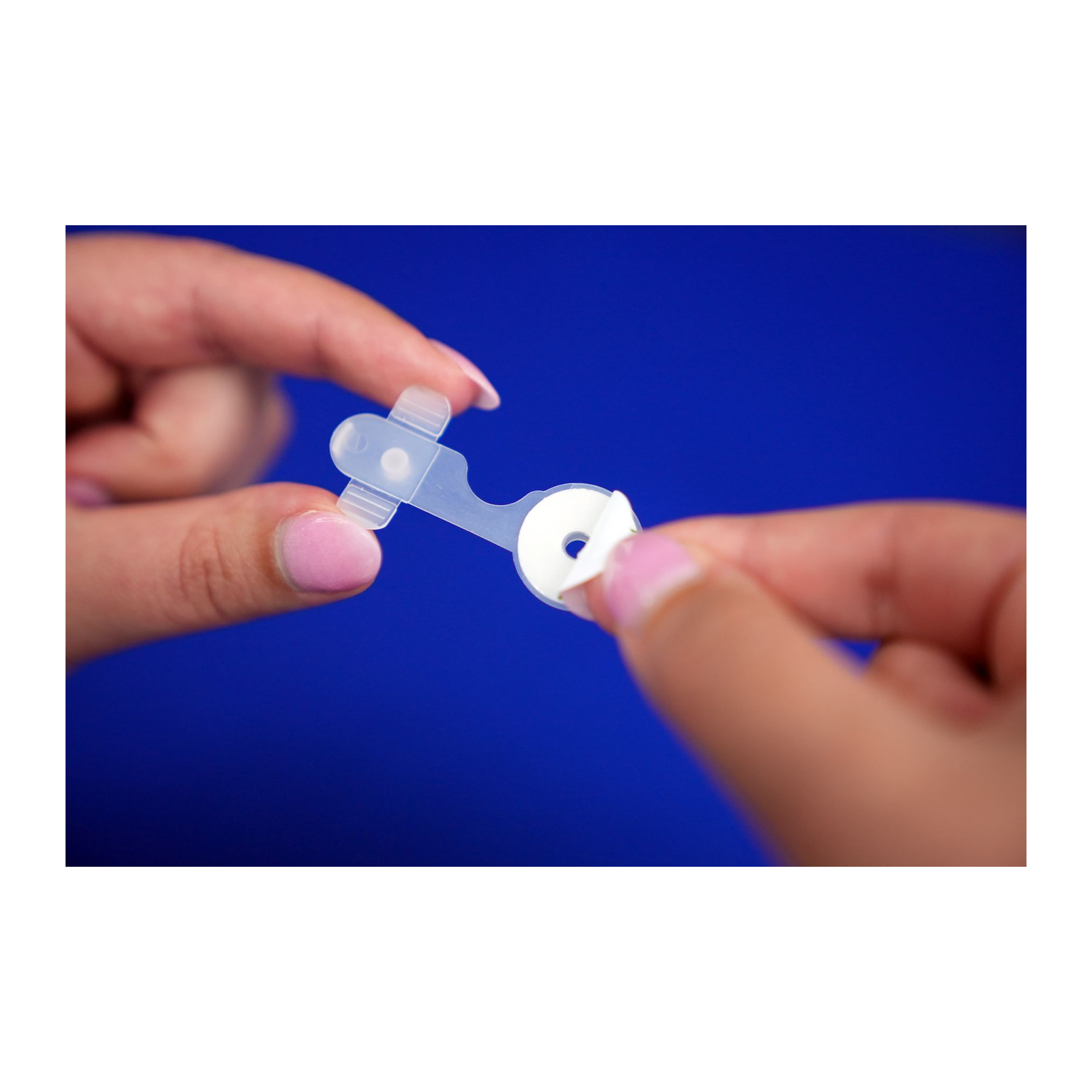 Removing the adhesive backing from an Osto-EZ-Vent